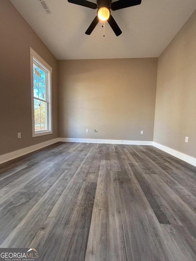 unfurnished room with dark hardwood / wood-style floors and ceiling fan