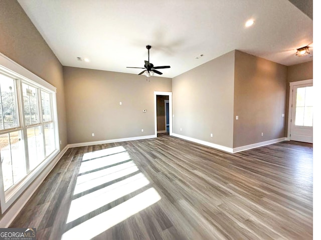 spare room with dark hardwood / wood-style flooring and ceiling fan