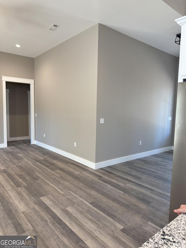 spare room featuring dark wood-type flooring