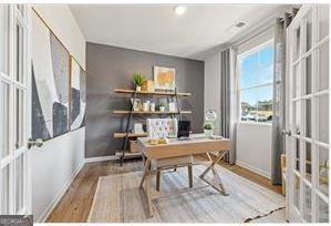 home office featuring baseboards, wood finished floors, and french doors