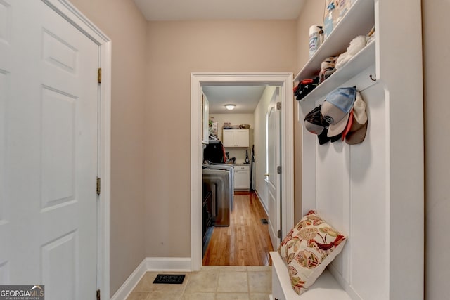 kitchen featuring pendant lighting, light tile patterned floors, ornamental molding, white appliances, and a notable chandelier