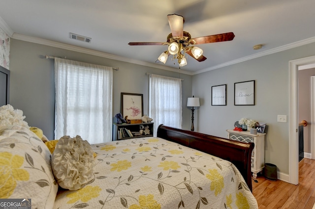 bathroom featuring tile patterned floors, a tub, crown molding, and vanity