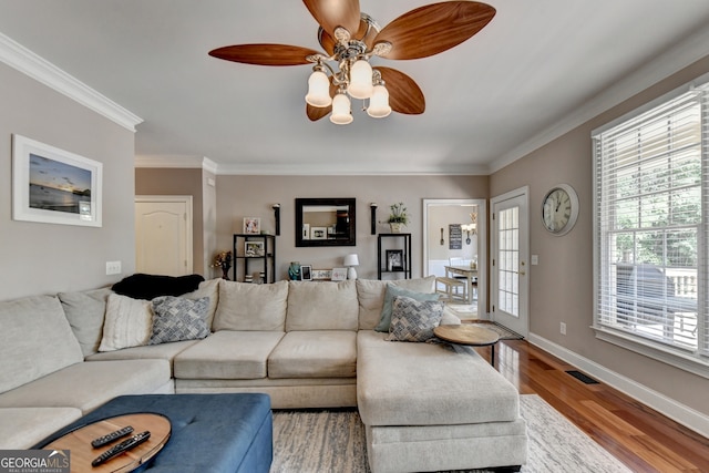 dining room featuring crown molding, hardwood / wood-style floors, and a chandelier