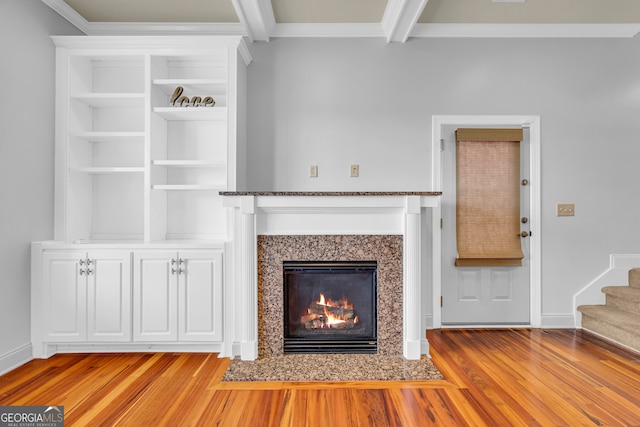 unfurnished living room with crown molding, beam ceiling, and light hardwood / wood-style flooring