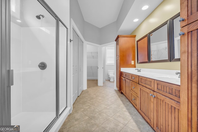 bathroom with vanity, tile patterned flooring, toilet, and an enclosed shower