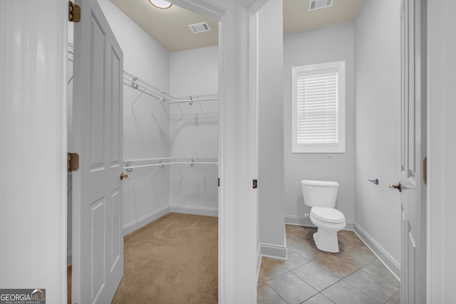 bathroom with tile patterned floors and toilet