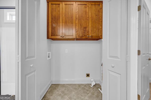 laundry room featuring hookup for an electric dryer, hookup for a washing machine, and cabinets