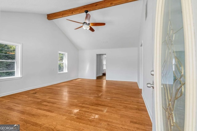 unfurnished living room with vaulted ceiling with beams, light wood-type flooring, and ceiling fan