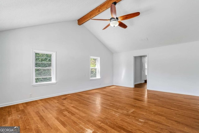 unfurnished living room featuring ceiling fan, beam ceiling, wood-type flooring, a textured ceiling, and high vaulted ceiling