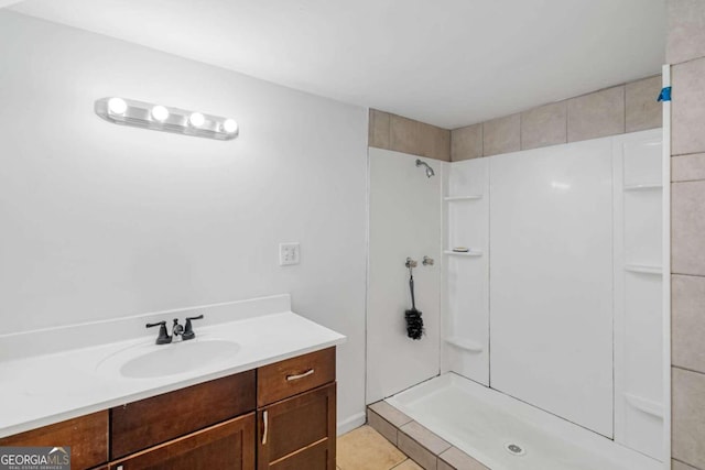 bathroom featuring vanity, tile patterned flooring, and walk in shower