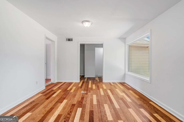 unfurnished room with light wood-type flooring