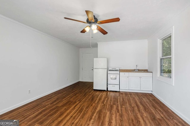 interior space with ceiling fan, dark wood-type flooring, white appliances, sink, and ornamental molding