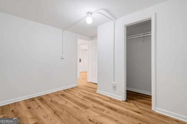 unfurnished bedroom featuring a closet and light hardwood / wood-style flooring