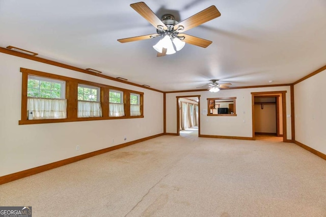 carpeted empty room featuring ornamental molding and ceiling fan