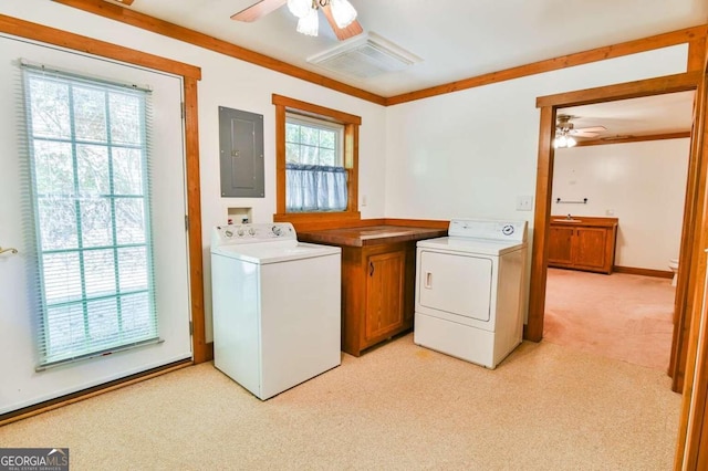 laundry room with washing machine and dryer, electric panel, a healthy amount of sunlight, and light carpet