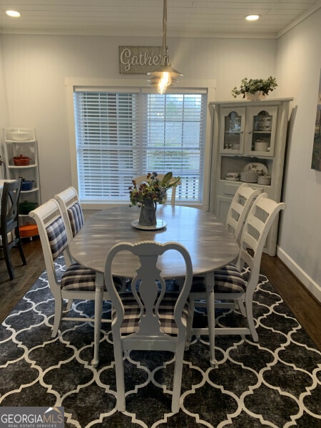 dining space featuring dark wood-type flooring