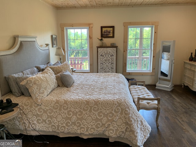 bedroom featuring wood ceiling, dark wood-type flooring, and multiple windows