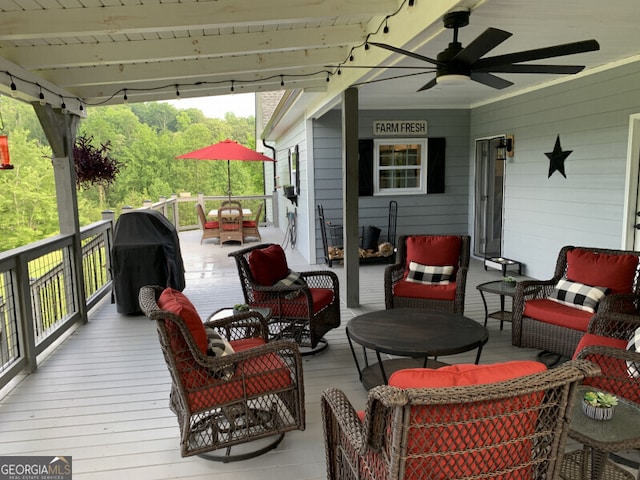 wooden deck with ceiling fan, area for grilling, and an outdoor hangout area