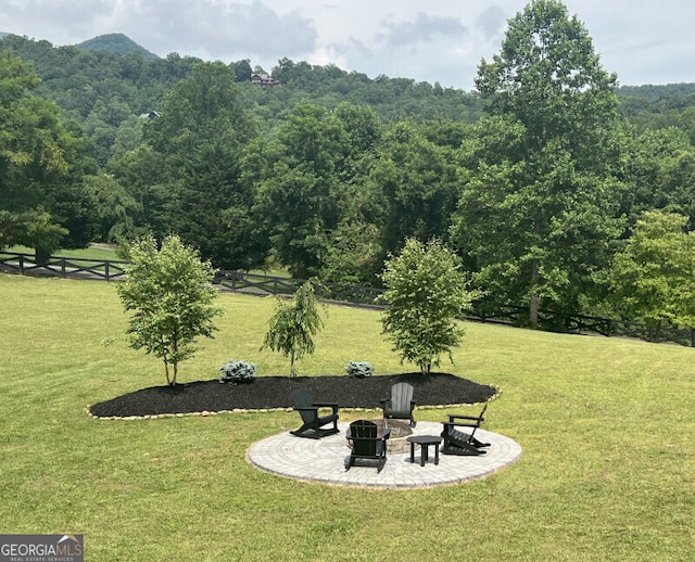 view of yard with an outdoor fire pit, a patio area, and a mountain view