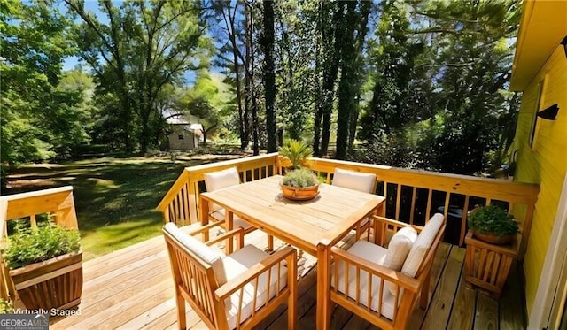 wooden deck featuring a yard