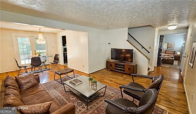 living room featuring hardwood / wood-style floors and a textured ceiling