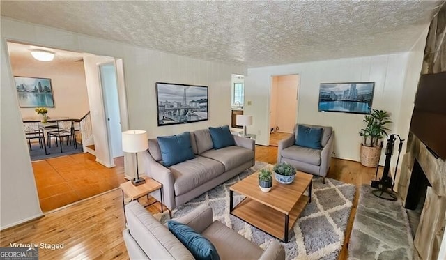 living room featuring a textured ceiling and hardwood / wood-style floors