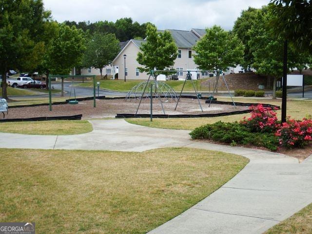 surrounding community with a yard and a playground