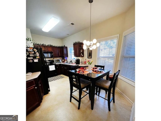 dining area featuring sink and a chandelier