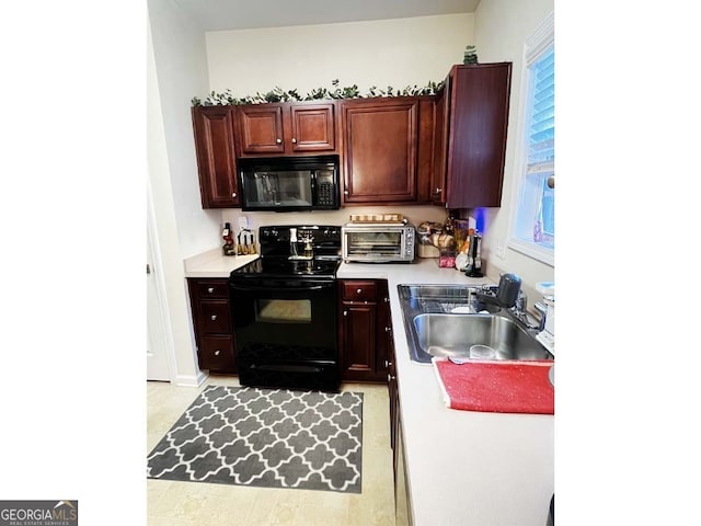 kitchen with plenty of natural light, black appliances, and sink