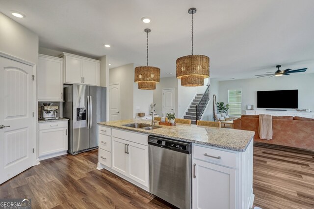 22 Allston Ln, Savannah, GA 31407 - kitchen with dark wood-type flooring, white cabinets, light stone counters, a sink, and appliances with stainless steel finishes