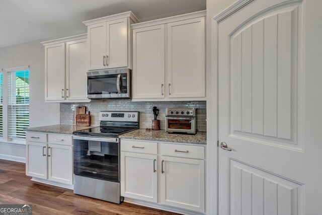 22 Allston Ln, Savannah, GA 31407 - kitchen with backsplash, stainless steel appliances, white cabinetry, and dark wood-type flooring