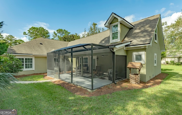 rear view of house featuring a lawn, a lanai, and a patio area