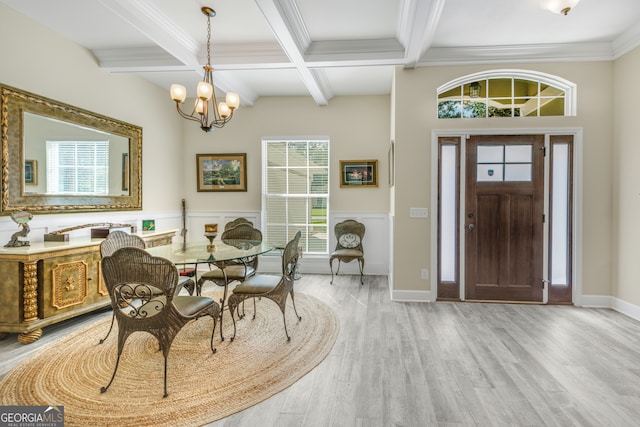 dining room with an inviting chandelier, light hardwood / wood-style flooring, plenty of natural light, and beam ceiling