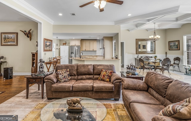 living room featuring sink, beam ceiling, ceiling fan with notable chandelier, crown molding, and light hardwood / wood-style floors