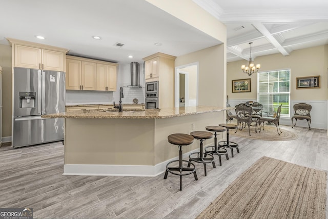 233 Cardinal Cir W, Saint Marys, GA 31558 - kitchen featuring wall chimney range hood, appliances with stainless steel finishes, a sink, light wood-style flooring, and coffered ceiling