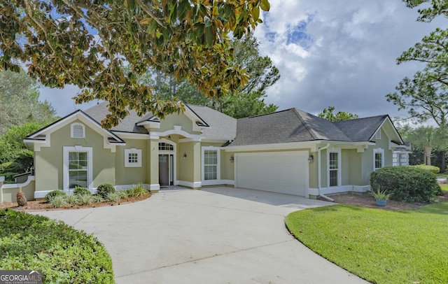 233 Cardinal Cir W, Saint Marys, GA 31558 - single story home with a garage, stucco siding, concrete driveway, and a shingled roof