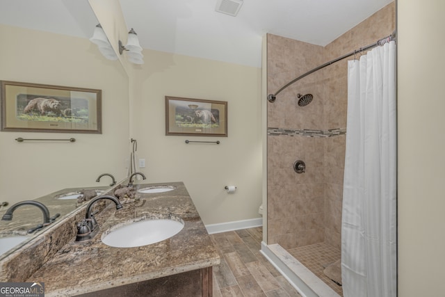 bathroom featuring wood-type flooring, a shower with curtain, vanity, and toilet