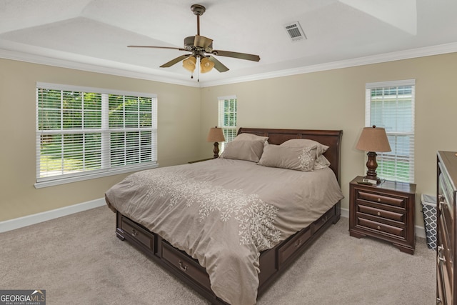 carpeted bedroom with ceiling fan, ornamental molding, and multiple windows