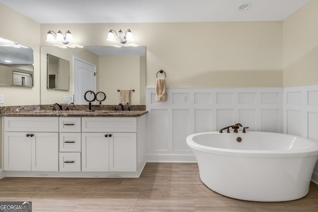 bathroom with vanity and a bath