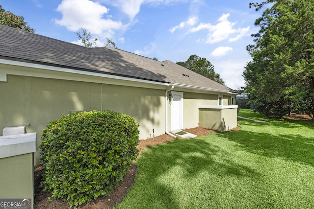 view of home's exterior with a yard