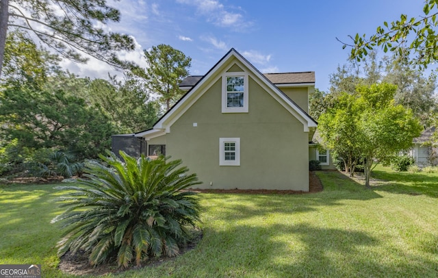 233 Cardinal Cir W, Saint Marys, GA 31558 - view of property exterior featuring a lawn and stucco siding