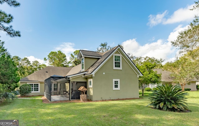 rear view of house with a yard and a patio area