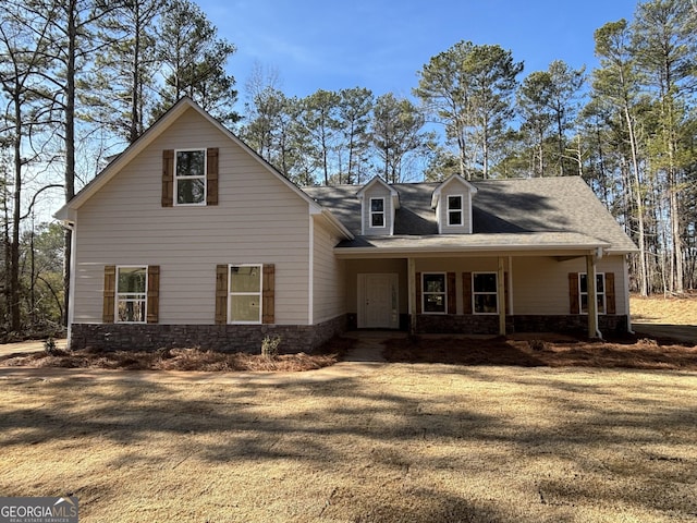 view of front of property with covered porch and a front lawn