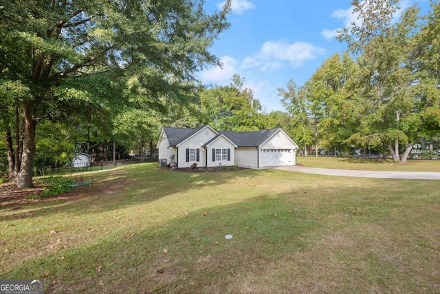 view of front of home with a garage and a front lawn