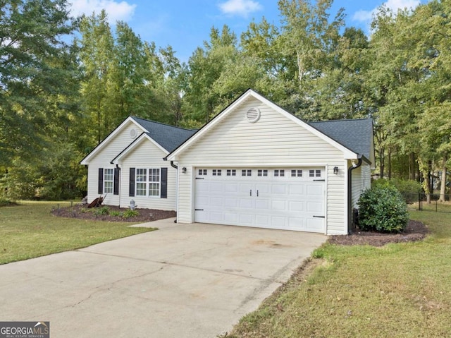 view of front of house with a front yard and a garage