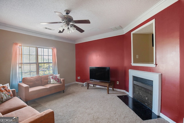 living room featuring crown molding, a textured ceiling, carpet floors, and ceiling fan