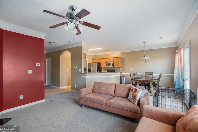 living room with crown molding, a textured ceiling, light colored carpet, and ceiling fan