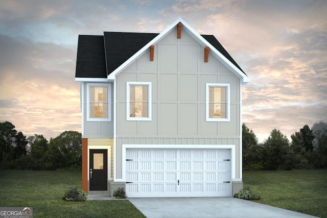 view of front of property featuring a garage and a lawn