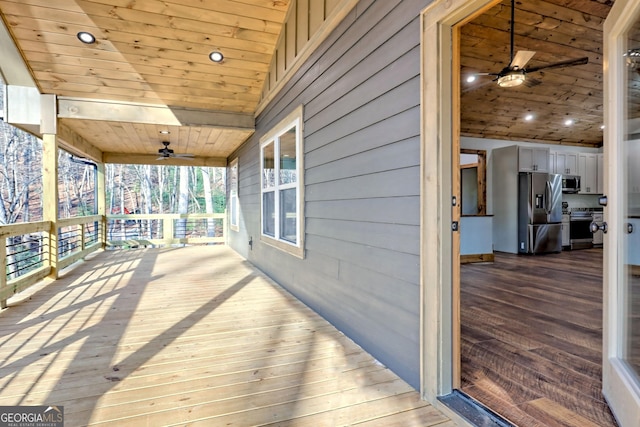 wooden deck featuring ceiling fan and a porch