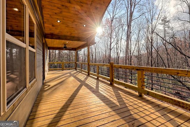 wooden deck featuring ceiling fan